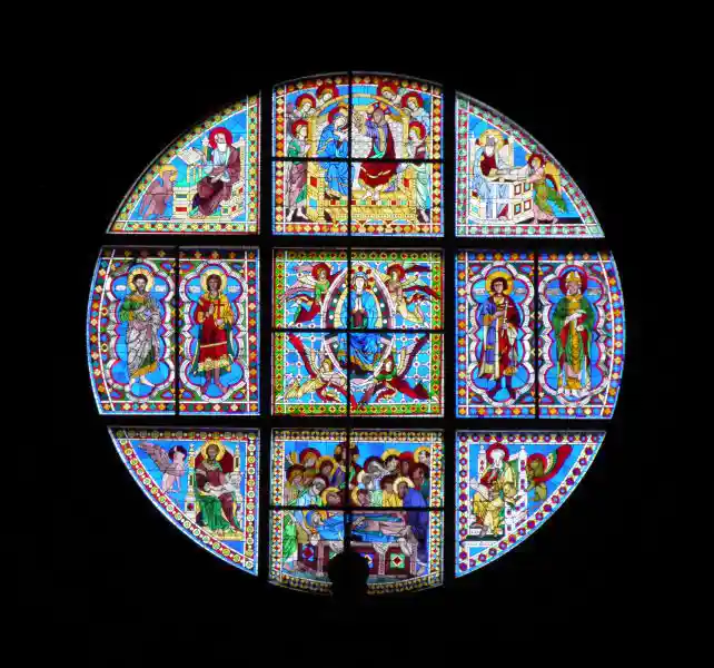Stained glass with different Christian scenes in the form of a circular cross